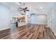 Spacious open-plan living room flowing into kitchen, with hardwood floors and vaulted ceiling at 515 Columbus Ave, Orange City, FL 32763