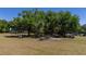 Outdoor recreation area with picnic tables, trees, a white building, and a parking lot at 515 Columbus Ave, Orange City, FL 32763