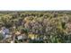A view showcases the backyard with mature trees, lush landscaping, and a covered porch at 519 N Clara Ave, Deland, FL 32720