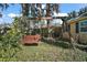 Spacious backyard with a unique swing set and lush greenery, perfect for relaxation at 519 N Clara Ave, Deland, FL 32720