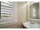 Bathroom featuring a classic vanity, mirror, and a bright window with shutters offering natural light at 519 N Clara Ave, Deland, FL 32720