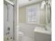 Bathroom featuring a shower, toilet, and vanity with a sink and a shuttered window at 519 N Clara Ave, Deland, FL 32720