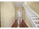 Inviting entryway with hardwood floors and white staircase at 519 N Clara Ave, Deland, FL 32720