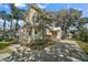 Charming home with manicured landscaping, a welcoming front porch, and a long driveway at 519 N Clara Ave, Deland, FL 32720