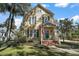 A charming two-story home with blue shutters, a front porch, and a well-manicured lawn at 519 N Clara Ave, Deland, FL 32720