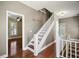 Hallway with hardwood floors, stairs, and a view into a bedroom space at 519 N Clara Ave, Deland, FL 32720