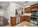 Well-lit kitchen featuring stainless steel appliances, granite countertops, and custom wood cabinets at 519 N Clara Ave, Deland, FL 32720