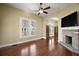 Bright living room with fireplace, hardwood floors and shuttered windows at 519 N Clara Ave, Deland, FL 32720