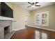 Spacious living room boasts fireplace, hardwood floors, and large windows at 519 N Clara Ave, Deland, FL 32720