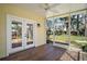Relaxing screened porch offering views of the backyard and a ceiling fan for comfort at 519 N Clara Ave, Deland, FL 32720