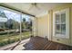 Cozy screened porch with wood flooring offers a relaxing outdoor space at 519 N Clara Ave, Deland, FL 32720
