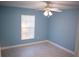 This bedroom has tile floors, fresh paint, a ceiling fan and a window with blinds at 5220 Curry Ford Rd # 303, Orlando, FL 32812