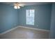 This bedroom has tile floors, fresh paint, a ceiling fan and a window with blinds at 5220 Curry Ford Rd # 303, Orlando, FL 32812