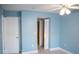This bedroom features a ceiling fan and view to two closets, fresh paint and tile floor at 5220 Curry Ford Rd # 303, Orlando, FL 32812