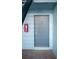 A view of the main door of the apartment. Number is 303. Includes fire extinguisher case at 5220 Curry Ford Rd # 303, Orlando, FL 32812