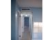 Hallway with multiple doorways, featuring tile flooring and overhead lighting at 5220 Curry Ford Rd # 303, Orlando, FL 32812