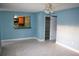 Bright living room featuring tile floors, a ceiling fan, and an opening to the kitchen area at 5220 Curry Ford Rd # 303, Orlando, FL 32812