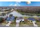 Stunning aerial view of a lakeside home with mature trees and lush landscaping in a desirable community at 5502 Willow Bend Trl, Kissimmee, FL 34758