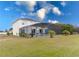Expansive backyard featuring a screened-in pool area, mature trees, and lush green grass at 5502 Willow Bend Trl, Kissimmee, FL 34758