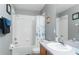 Clean bathroom with a shower and tub combination, white tile, and functional layout at 5502 Willow Bend Trl, Kissimmee, FL 34758
