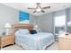 Relaxing bedroom with a queen-sized bed, coastal decor, ceiling fan, and a bright window at 5502 Willow Bend Trl, Kissimmee, FL 34758