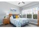 Serene bedroom with a ceiling fan, windows, wood floors, and bright natural light at 5502 Willow Bend Trl, Kissimmee, FL 34758