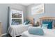 Bright bedroom with twin beds, neutral tones, and view to screened outdoor area at 5502 Willow Bend Trl, Kissimmee, FL 34758