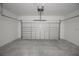 Spacious two-car garage with painted walls and floor, equipped with an automatic door at 6038 Sw 154Th Place Rd, Ocala, FL 34473