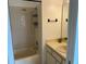 Bathroom features a shower-tub combo, a vanity with a cream countertop, and a framed mirror at 6104 Topher Trl # 6104, Mulberry, FL 33860