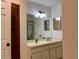 Bathroom vanity with a large mirror, pendant lighting, and a shower with stained glass at 6104 Topher Trl # 6104, Mulberry, FL 33860