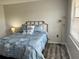 Cozy bedroom features a comfortable bed with stylish bedding, a sleek floor lamp, and natural light from the window at 6104 Topher Trl # 6104, Mulberry, FL 33860