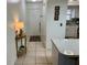 Inviting entryway with tiled floor leading to the kitchen, featuring a charming decor table at 6104 Topher Trl # 6104, Mulberry, FL 33860