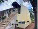 Two-story condominium building featuring a private entry with stairs and a green awning to block out the sun at 6104 Topher Trl # 6104, Mulberry, FL 33860
