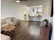 Bright and airy living room with hardwood flooring, open to the kitchen, and modern decor at 6104 Topher Trl # 6104, Mulberry, FL 33860