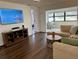 Comfortable living room featuring hardwood floors, a large TV, and an adjacent sunroom at 6104 Topher Trl # 6104, Mulberry, FL 33860