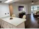 Kitchen and living room with breakfast bar, tv, and pass through window to a sitting area at 6104 Topher Trl # 6104, Mulberry, FL 33860