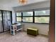 Bright home office space with white desk and views of the landscape through a large window at 6104 Topher Trl # 6104, Mulberry, FL 33860