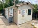 Exterior shot of the community pool building with posted pool rules and required safety gear for residents at 6104 Topher Trl # 6104, Mulberry, FL 33860