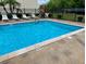 Community swimming pool with an ample swimming space with an attached patio area and outdoor furniture at 6104 Topher Trl # 6104, Mulberry, FL 33860