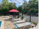 Community pool with lounge chairs, tables and chairs, and a jacuzzi nearby for residents to enjoy at 6104 Topher Trl # 6104, Mulberry, FL 33860