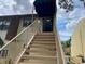 Exterior view of the staircase leading to the condo's entrance, with a protective awning above at 6104 Topher Trl # 6104, Mulberry, FL 33860