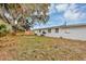 Spacious backyard with a privacy fence and mature trees surrounding the home at 6312 Appian Way, Orlando, FL 32807