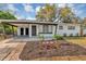 Charming single-story home featuring a covered carport and freshly landscaped front yard with flowers at 6312 Appian Way, Orlando, FL 32807