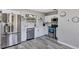 Modern kitchen with stainless steel appliances, white cabinetry, and marble countertops at 6312 Appian Way, Orlando, FL 32807