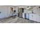 Modern kitchen with stainless steel appliances, white cabinetry, and stylish dining area at 6312 Appian Way, Orlando, FL 32807