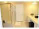 Bright bathroom features a glass-enclosed shower and a vanity with dual sinks at 6453 Alcalde Ct # 104, Orlando, FL 32835