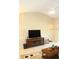 Bright living room features high ceilings, tile floors, and a large entertainment center at 6453 Alcalde Ct # 104, Orlando, FL 32835