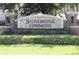 Entrance sign for Stonebridge Commons with manicured landscaping and brick pillars at 6453 Alcalde Ct # 104, Orlando, FL 32835