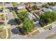 An aerial view of a single-Gathering home featuring a well-maintained lawn and mature trees in a residential neighborhood at 6749 Westlake Blvd, Orlando, FL 32810