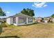 Lush backyard featuring a screened-in patio, perfect for outdoor enjoyment and relaxation at 6749 Westlake Blvd, Orlando, FL 32810